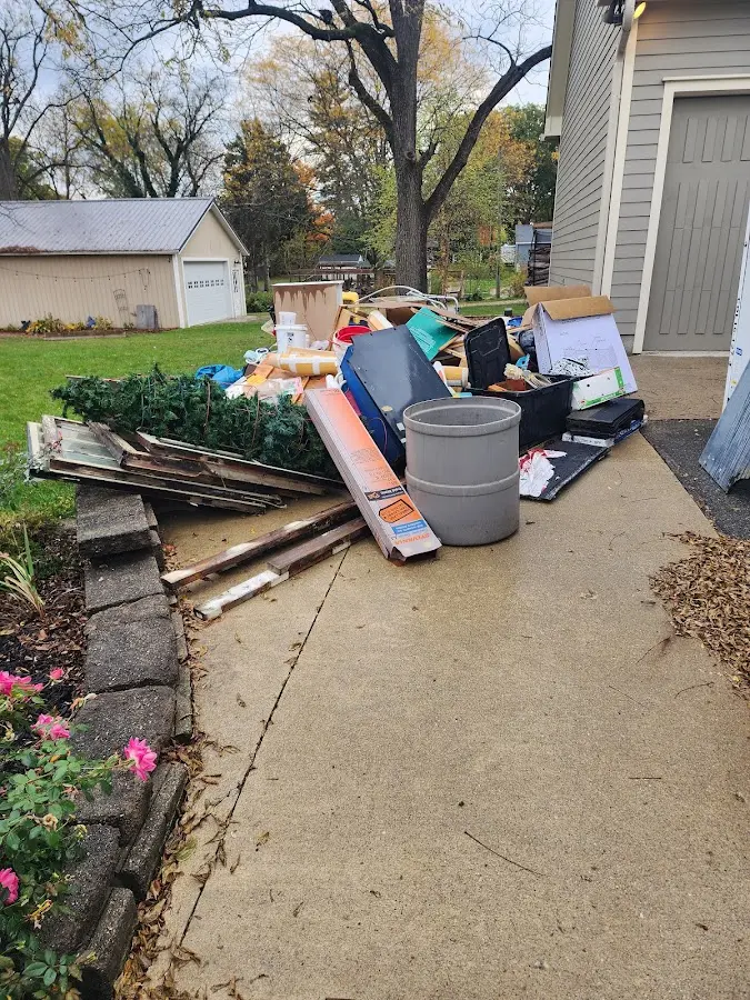 Dumpster being loaded with debris for 12 Yard Dumpster Rental in Tuckahoe